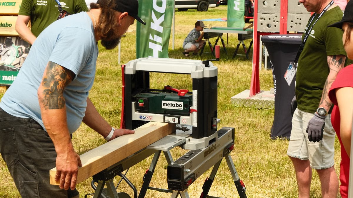 Hands-on carpentry demonstration at outdoor event in Katowice, Poland. Metabo tools in use.